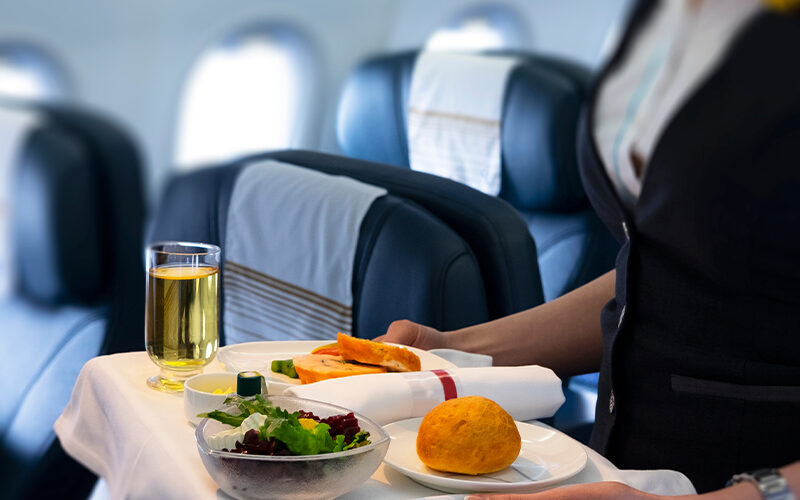 flight-attendant-serving-meal تفاوت کلاس های پروازی